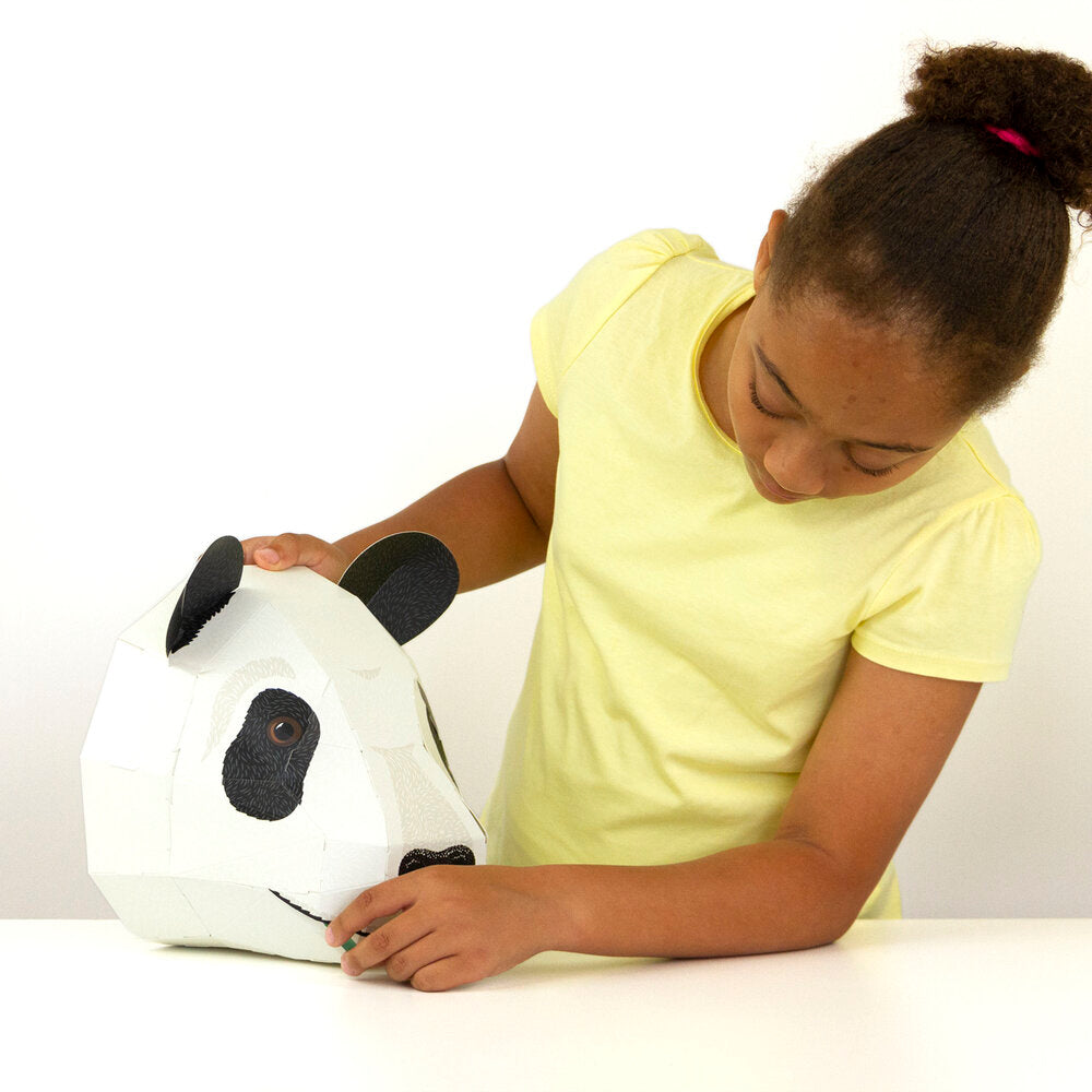 girl assembling cardboard panda head