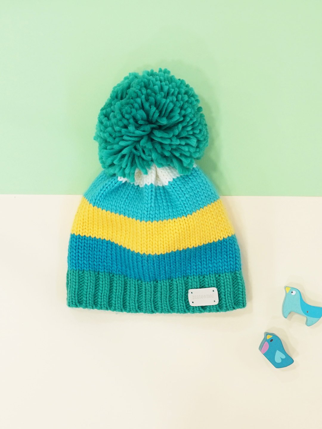 blue green and mustard knitted bobble hat with pom pom