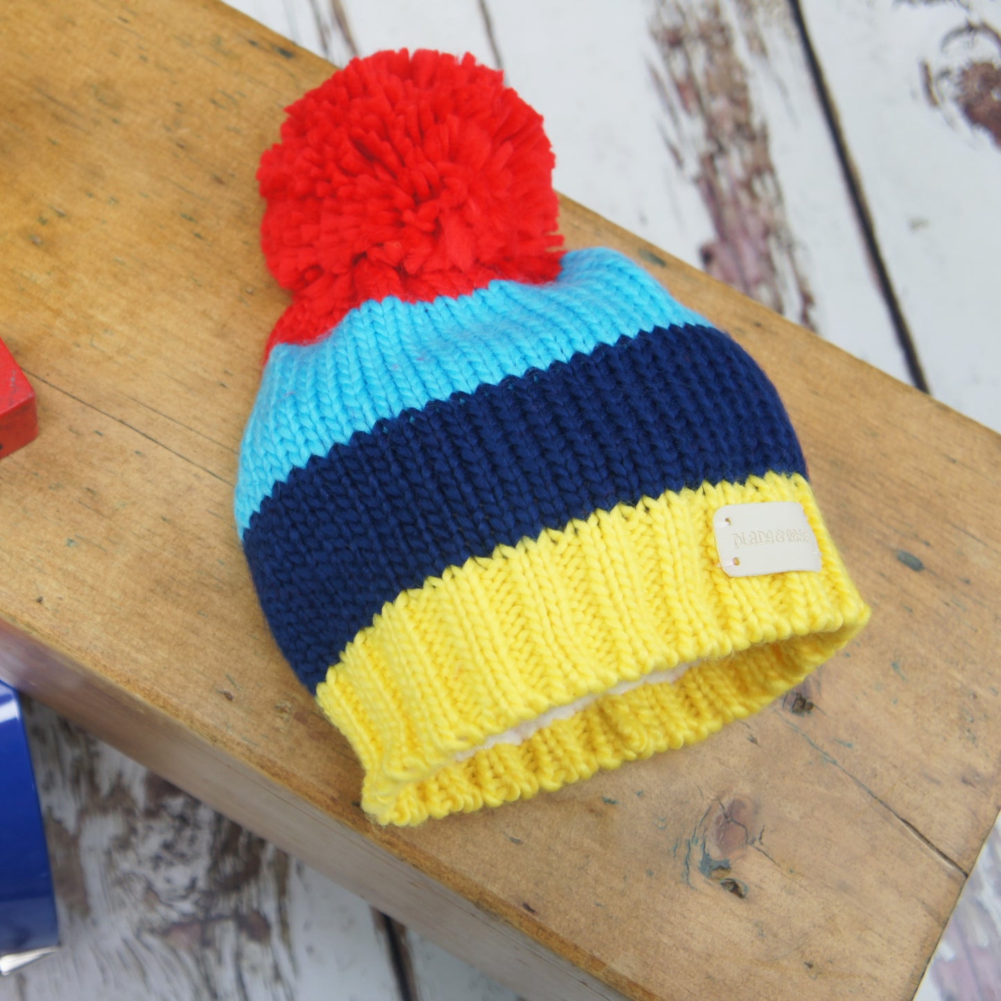 Blade & Rose blue & yellow striped bobble hat with large red pom pom